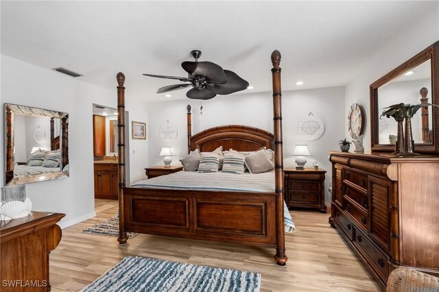 bedroom featuring ensuite bathroom and light hardwood / wood-style flooring