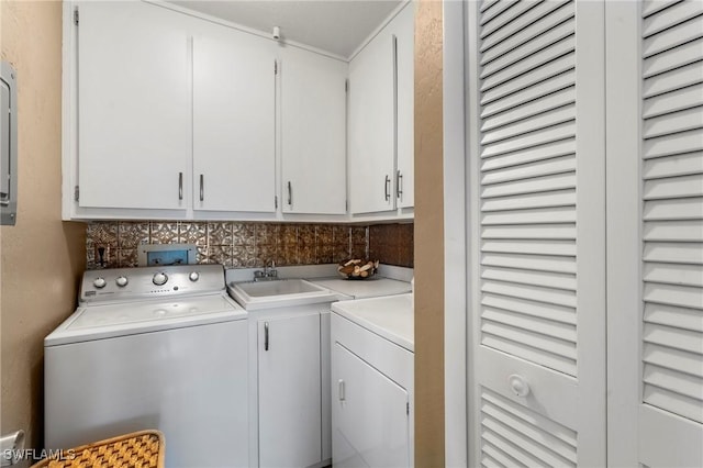 washroom featuring cabinets, washer and clothes dryer, and sink