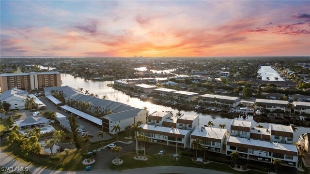 aerial view at dusk with a water view