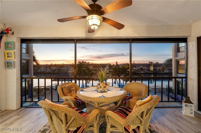 sunroom / solarium with a water view