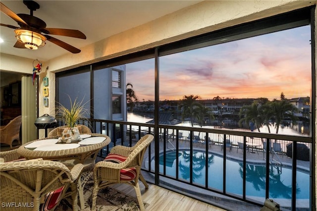 sunroom / solarium featuring a water view