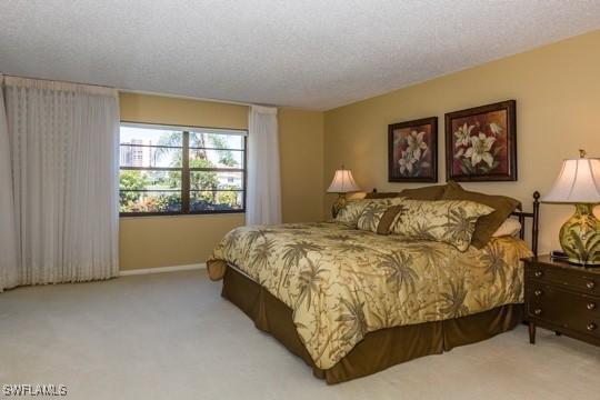 carpeted bedroom featuring a textured ceiling