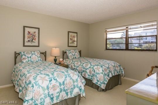 bedroom with carpet floors and a textured ceiling