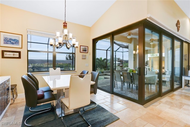 dining room with a notable chandelier and vaulted ceiling