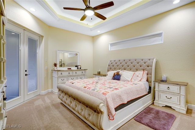 bedroom featuring a raised ceiling, light colored carpet, ceiling fan, and french doors