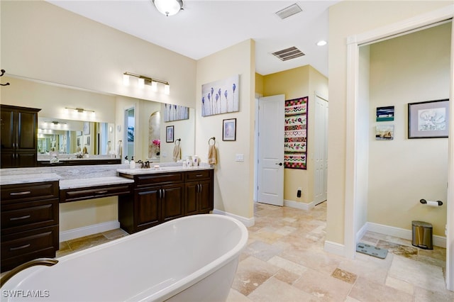 bathroom featuring a washtub and vanity