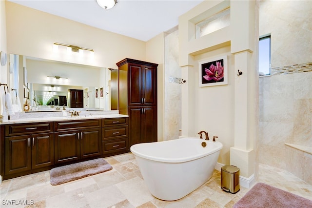 bathroom featuring vanity and independent shower and bath