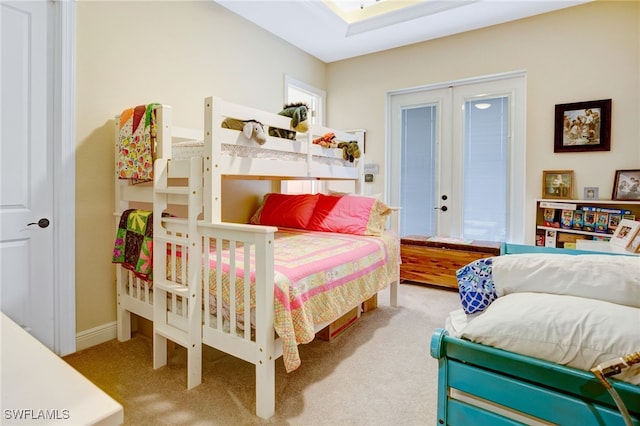 bedroom featuring french doors and carpet flooring