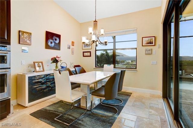 dining room with plenty of natural light, a notable chandelier, and vaulted ceiling