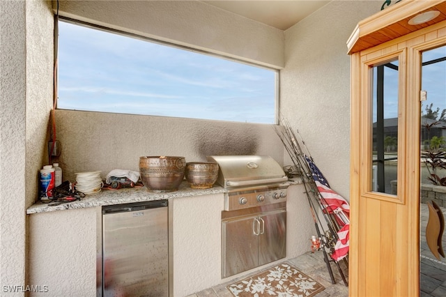 view of patio with area for grilling and exterior kitchen