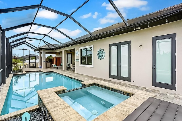 view of swimming pool featuring french doors, glass enclosure, a patio area, and an in ground hot tub