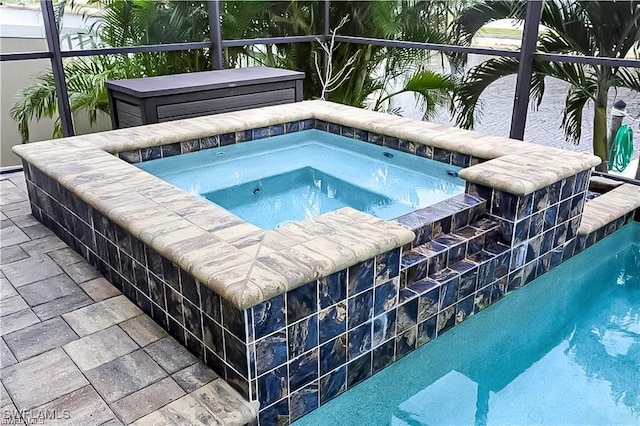 view of swimming pool featuring an in ground hot tub