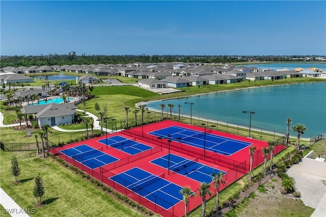 drone / aerial view featuring a water view and a residential view