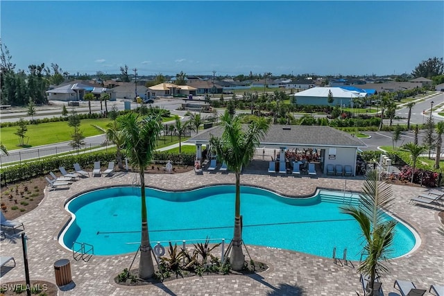 community pool featuring a patio area and fence