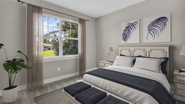 bedroom featuring light wood-type flooring and baseboards