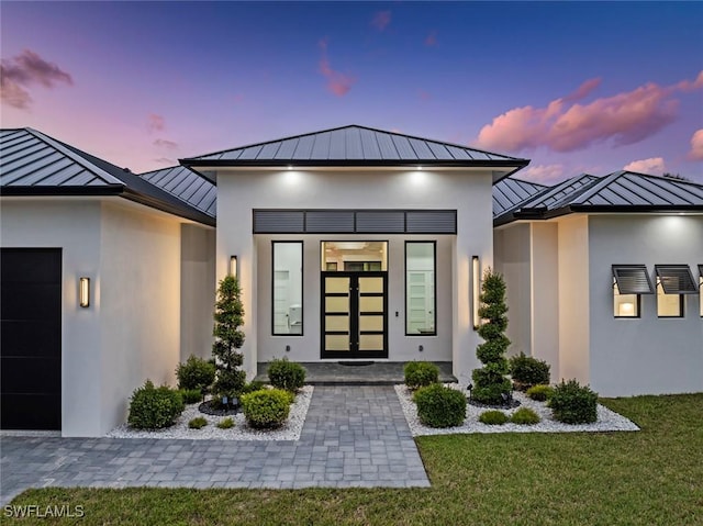 exterior entry at dusk with a yard