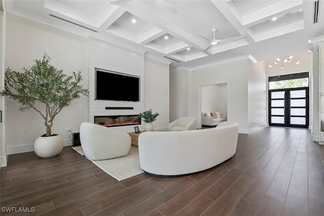 living room with dark wood-type flooring, ceiling fan, coffered ceiling, and beamed ceiling