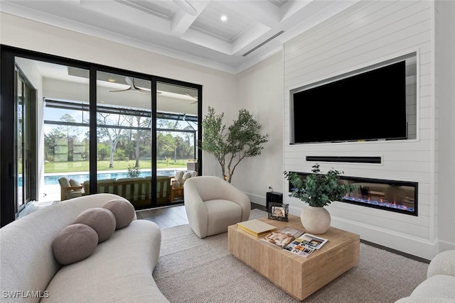 living room featuring beamed ceiling, ornamental molding, hardwood / wood-style flooring, and coffered ceiling