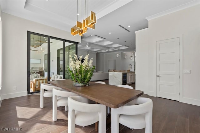 dining area featuring crown molding, sink, beverage cooler, and dark hardwood / wood-style floors