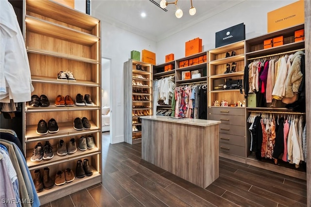 spacious closet featuring a chandelier