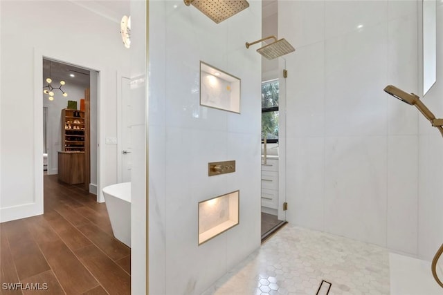 bathroom with hardwood / wood-style flooring, a towering ceiling, and independent shower and bath