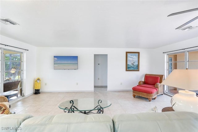 tiled living room featuring ceiling fan