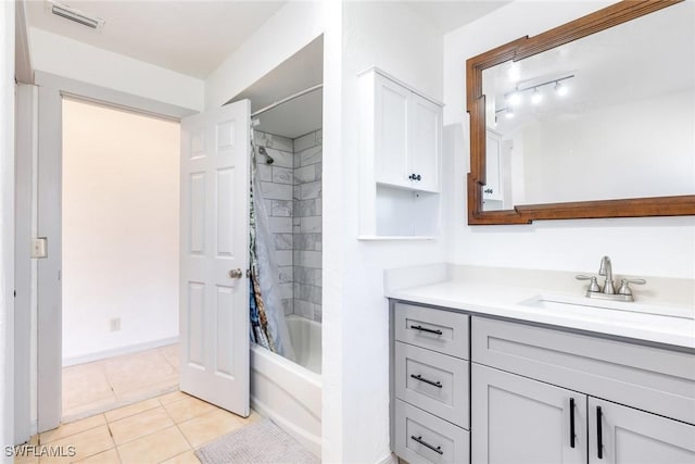 bathroom featuring tile patterned flooring, vanity, and shower / bath combination with curtain