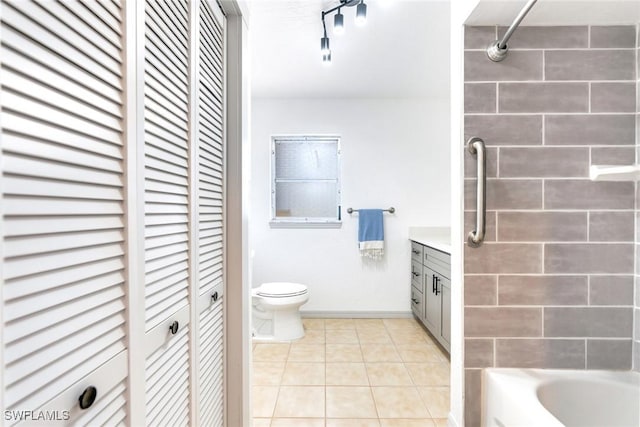 bathroom with tile patterned flooring, vanity, and toilet