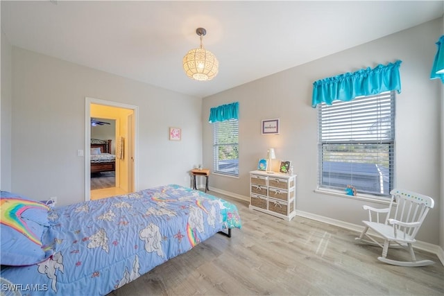 bedroom featuring wood-type flooring and multiple windows