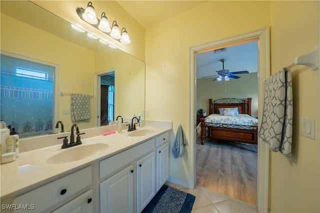 bathroom with tile patterned flooring, vanity, and ceiling fan