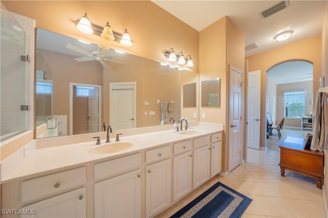 bathroom with ceiling fan, tile patterned flooring, vanity, and walk in shower