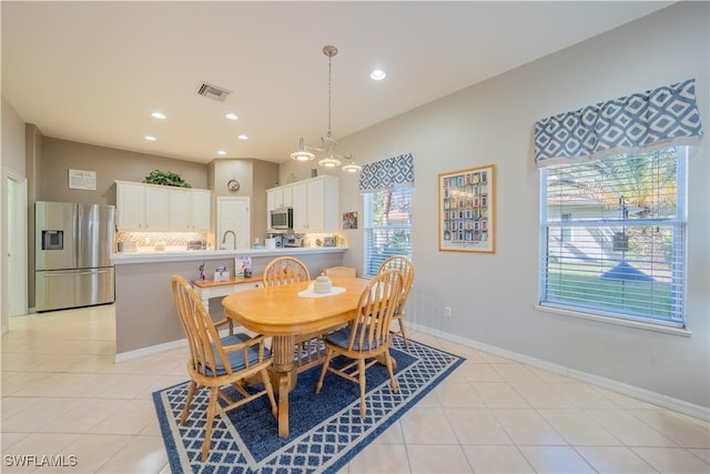 tiled dining area featuring sink