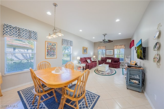 dining room featuring light tile patterned floors and ceiling fan with notable chandelier