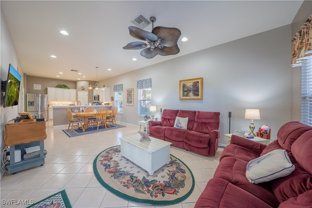 living room featuring ceiling fan and light tile patterned floors