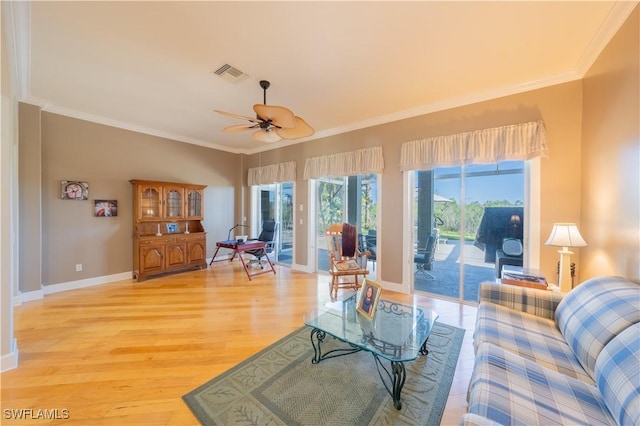 living room featuring hardwood / wood-style floors, ceiling fan, and crown molding