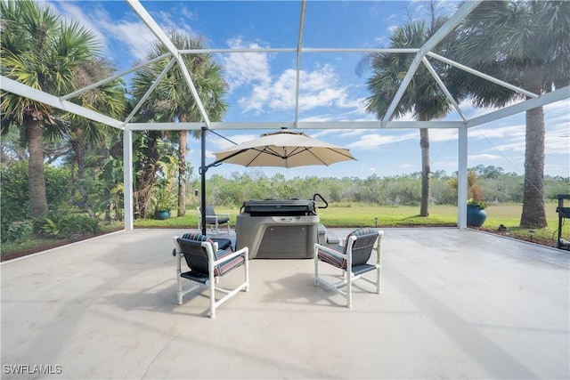 view of patio with area for grilling and glass enclosure