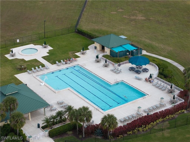 view of pool featuring a patio area and a yard