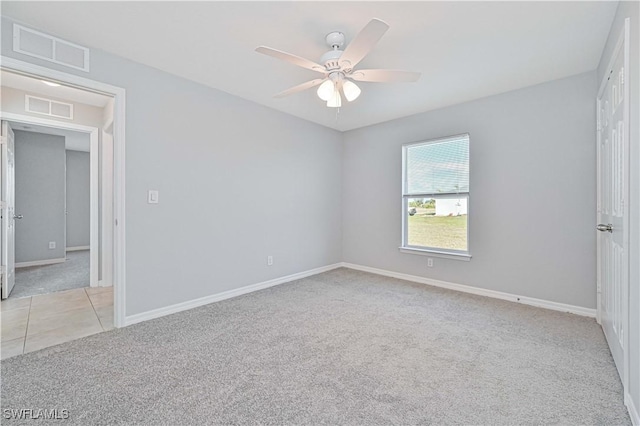 empty room featuring light carpet and ceiling fan