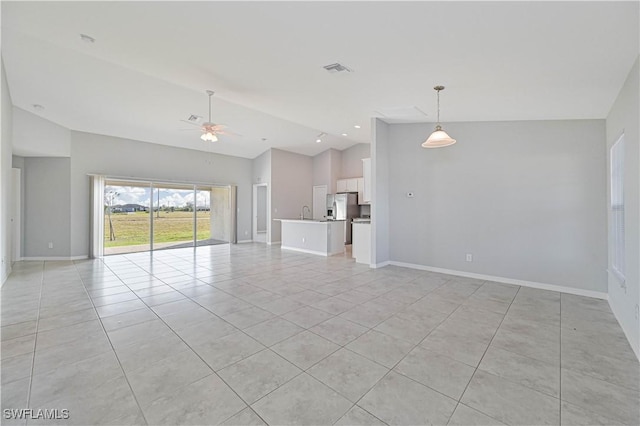 unfurnished living room featuring vaulted ceiling, ceiling fan, and light tile patterned flooring