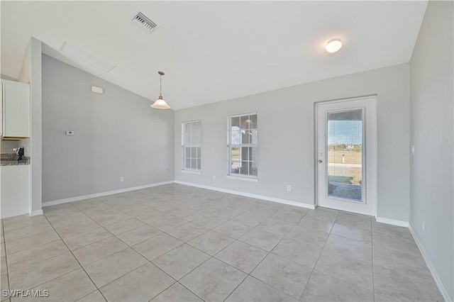 tiled spare room with lofted ceiling