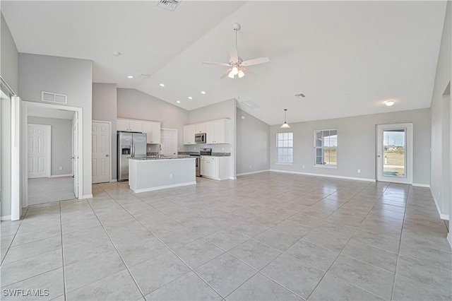 unfurnished living room featuring high vaulted ceiling, light tile patterned floors, and ceiling fan