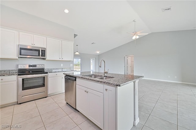 kitchen featuring white cabinetry, appliances with stainless steel finishes, sink, and a center island with sink