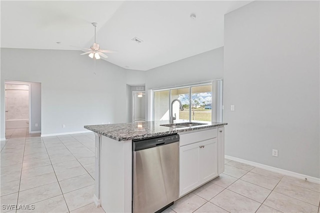 kitchen with stone countertops, white cabinetry, sink, stainless steel dishwasher, and a center island with sink