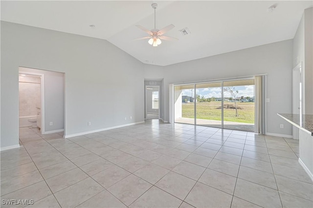 empty room with light tile patterned flooring, high vaulted ceiling, and ceiling fan