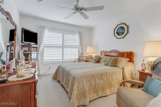 bedroom with ceiling fan and light colored carpet