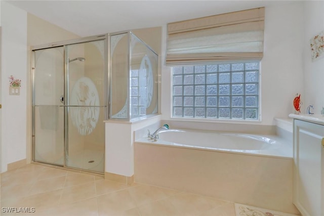 bathroom featuring tile patterned floors, vanity, and plus walk in shower