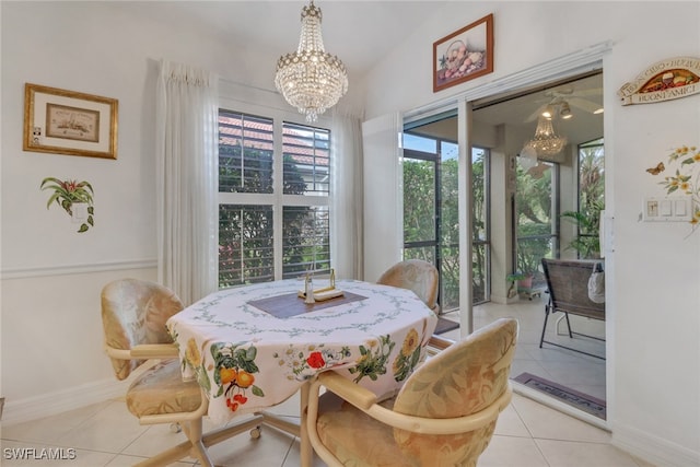 dining room featuring lofted ceiling, an inviting chandelier, and light tile patterned flooring