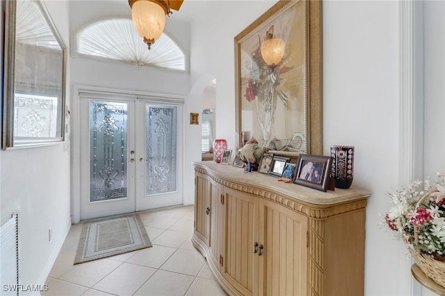 foyer featuring light tile patterned floors and french doors