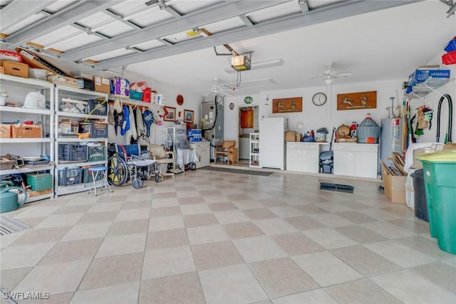 garage featuring ceiling fan, electric water heater, and a garage door opener