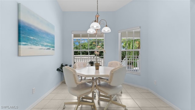 dining room featuring light tile patterned flooring and a chandelier